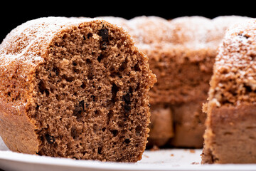 Close-up texture of a homemade cupcake cut with chocolate chips.