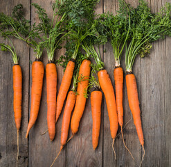 Fresh carrots bunch on rustic background. Healthy vegan vegetable food.