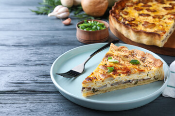 Delicious pie with mushrooms and cheese served on grey wooden table