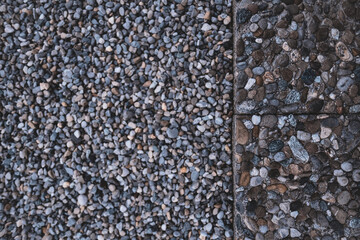 a bird's perspective, abstract shot of a stony garden slab which is located next to a cold gravel bed