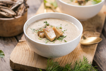 Homemade mushroom cream soup with sliced dry mushrooms. Top view