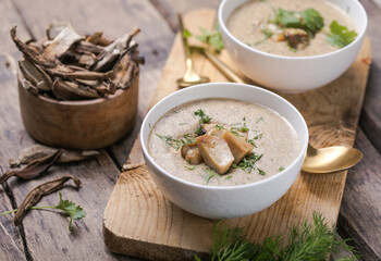 Homemade mushroom cream soup with sliced dry mushrooms. Top view