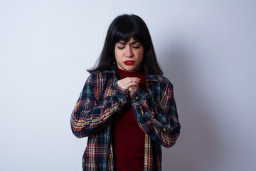 Sad Beautiful young Caucasian woman standing against white background feeling upset while spending...