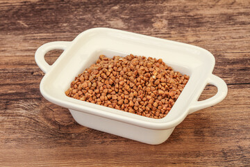 Raw buсkwheat cereal in the bowl