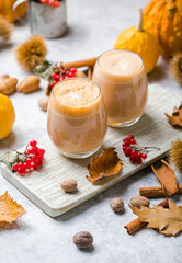 Pumpkin latte in a glasses. Autumn drink for Halloween or Thanksgiving.