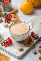 Pumpkin latte in mug. Autumn drink for Halloween or Thanksgiving.