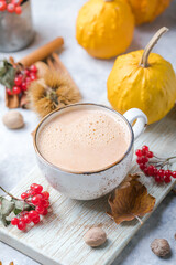 Pumpkin latte in mug. Autumn drink for Halloween or Thanksgiving.