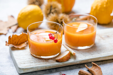 hot pumpkin punch or sangria in a glass with apple. Halloween and Thanksgiving beverage. Traditional autumn, winter drinks and cocktails