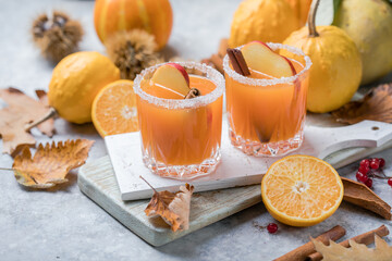 pumpkin punch or sangria in a glass with apple, cinnamon. Halloween and Thanksgiving. Traditional...