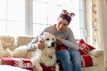 Boy and his dog enjoying Christmas together at home 
