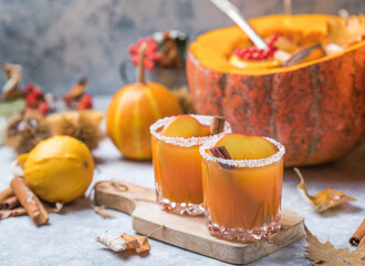 Pumpkin punch or sangria in a big pumpkin. Halloween and Thanksgiving. Traditional autumn, winter drinks and cocktails