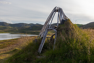 Wooden poles for Sami traditional shelter in tundra, Skarsvag, Northern Norway