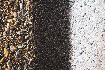 an abstract shot of a roadside with the safety line in white and gravel next to it