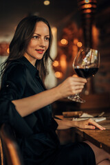 woman toasting with glass of wine