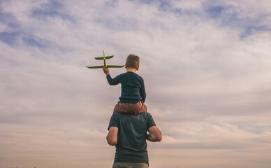 Happy child playing outdoors. Boy play airplane.  Little kid dreams of being a pilot.