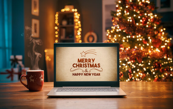 Christmas wishes on a laptop and Christmas tree - Powered by Adobe