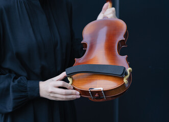 woman holding violin shoulder rest © Xiuxia Huang
