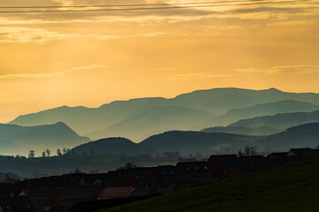 Colourful skies over Penrith and the hazy lake district fells