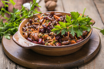 Hearty homemade salad with  beans, spicy carrots and nuts