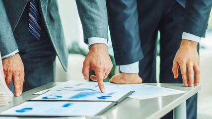 business partners discuss the financial schedules of the new project