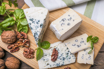 Fourme d'ambert blue cheese  and walnuts. Wooden background. Top view