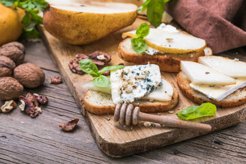 Toast or canape  with goat cheese, basil, honey, nuts.  Delicious appetizer, ideal as an aperitif.