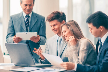 successful business team discussing a plan of the company in the office