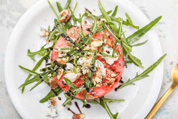 summer watermelon salad with blue cheese , arugula on light background. Healthy food, clean eating