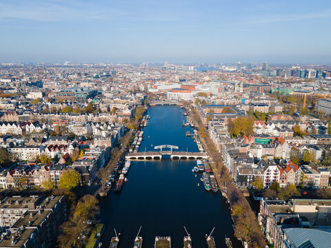 Amsterdam, The Netherlands, 7th November 2020 Aerial view of the Magere Brug Amsterdam And the river Amstel, City hall and Hermitage autumn