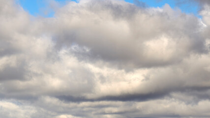 Dark clouds against a blue sky