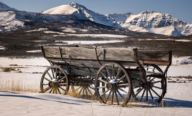 Fototapeta premium A heritage wooden horse drawn wagon on the Alberta prairies by Waterton National Park in the Canadian Rockies.