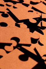 Close up view of brown pieces of a puzzle in a mess. Disorganized.
