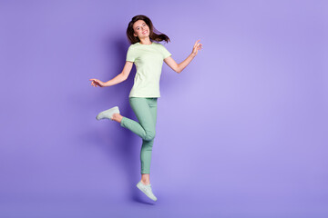 Photo portrait full body view of cute woman jumping up isolated on vivid purple colored background