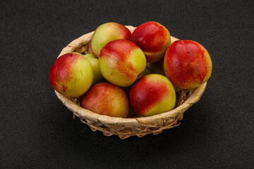 Sweet small nectarines in the basket