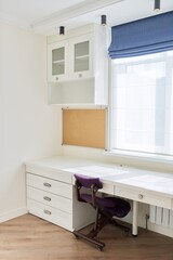 Interior, white furniture, table and chair near the window, cork board on wall