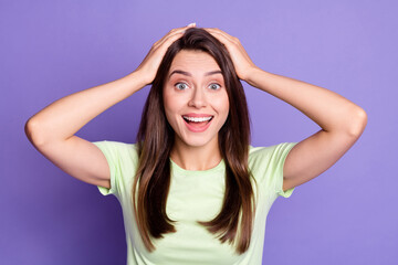 Fototapeta premium Photo portrait of surprised shocked girl keeping hands on head isolated on vivid purple color background