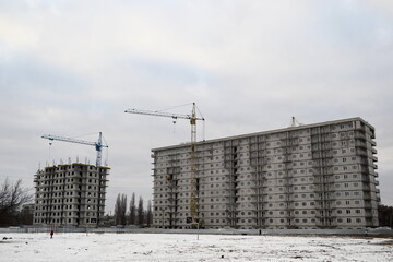 Construction site with cranes in winter