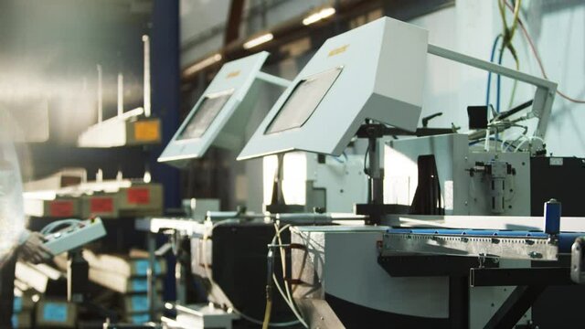 Buzzsaw cutting metal profile automatically in big warehouse/workshop 4k PRORES Footage