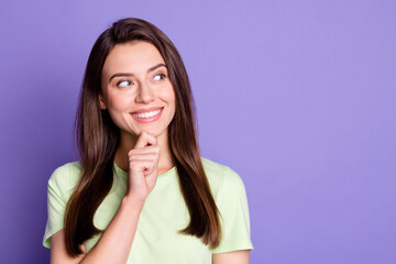 Fototapeta premium Portrait of funky young girl smile looking empty space arm on chin isolated on vivid purple color background