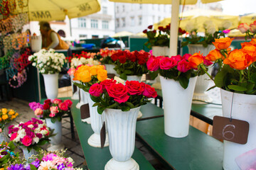 Street flower shop. Flowers in vases on the street