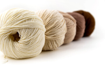 Balls of yarn for knitting brown flowers on a white background.