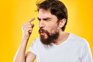 bearded man gesturing with hands studio lifestyle discontent yellow background