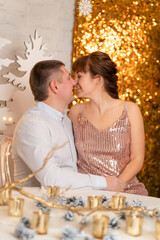 A guy and a girl kiss among the sparkles at a party