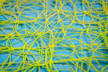 Abstract background of yellow threads on blue