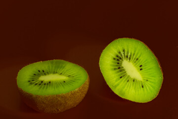 Beautiful fresh kiwi on a brown background close-up.