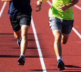 Fototapeta na wymiar Two runners running on a red track