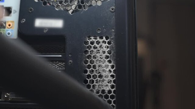 Close up of cleaning thick dust from computer ports with vacuum cleaner.