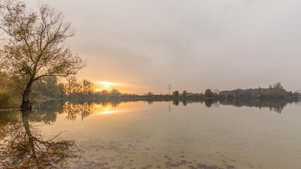 sunset over the lake in Reichstett in France at fall