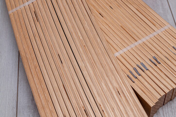 Obraz na płótnie Canvas unpacked packaging of birch slats on the floor