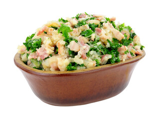 Traditional Irish Colcannon in a rustic earthenware dish, Colcannon is made with mashed potato and kale or cabbage, isolated on a white background